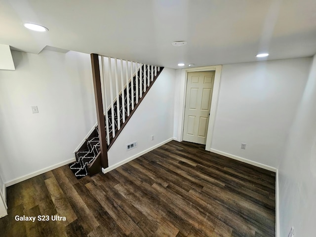 basement featuring dark hardwood / wood-style flooring