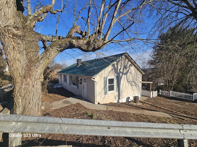 view of side of home with central AC unit