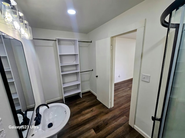 walk in closet with sink and dark hardwood / wood-style flooring