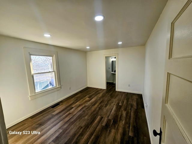 empty room with dark hardwood / wood-style floors