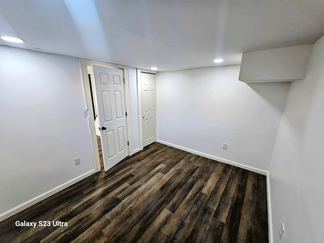 basement featuring dark hardwood / wood-style flooring