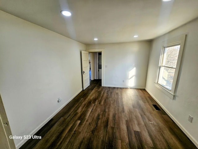 empty room featuring dark wood-type flooring