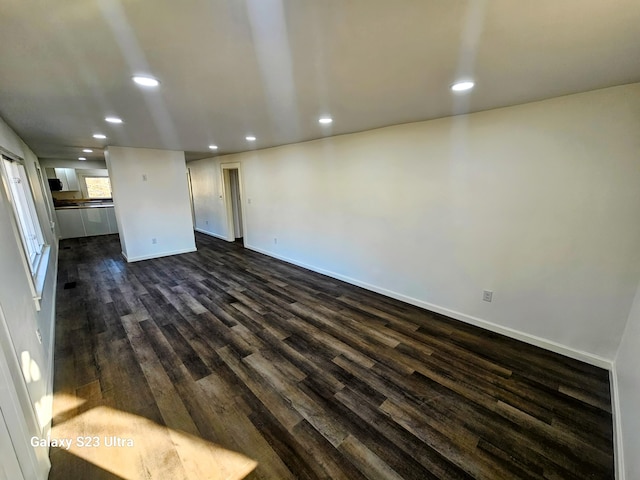 unfurnished living room with dark hardwood / wood-style flooring