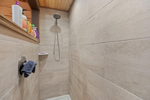 interior details with a tile shower