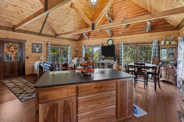 kitchen featuring a kitchen island, dark hardwood / wood-style flooring, wooden ceiling, and beam ceiling