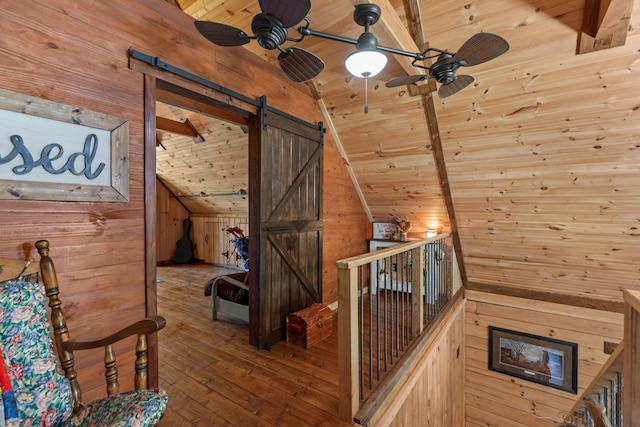 unfurnished room featuring vaulted ceiling with beams, ceiling fan, wood walls, and wooden ceiling