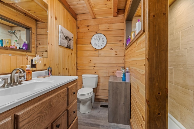 bathroom featuring wood walls, wooden ceiling, hardwood / wood-style flooring, toilet, and beamed ceiling