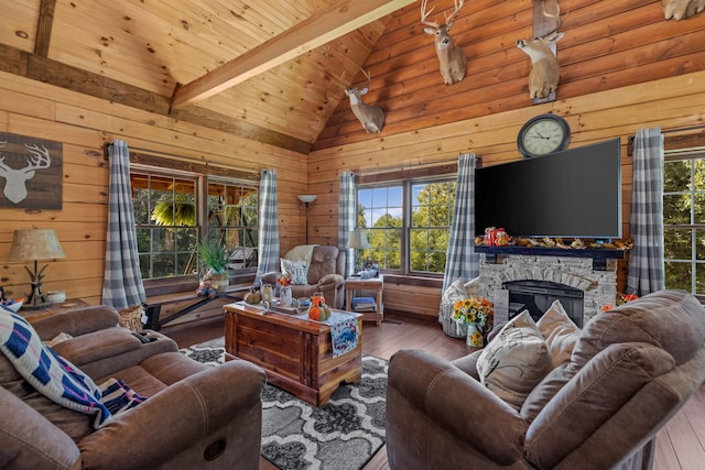 living room featuring wood walls, beamed ceiling, wooden ceiling, and hardwood / wood-style flooring