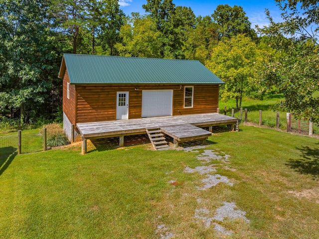 exterior space with a garage, an outdoor structure, and a lawn