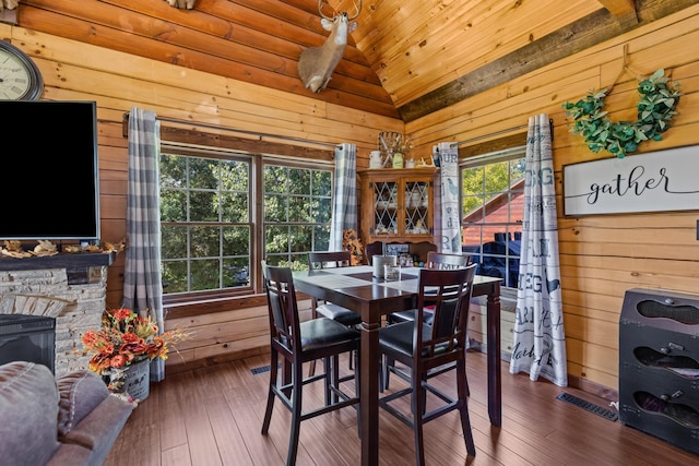 dining area featuring wood walls, dark hardwood / wood-style flooring, and wood ceiling