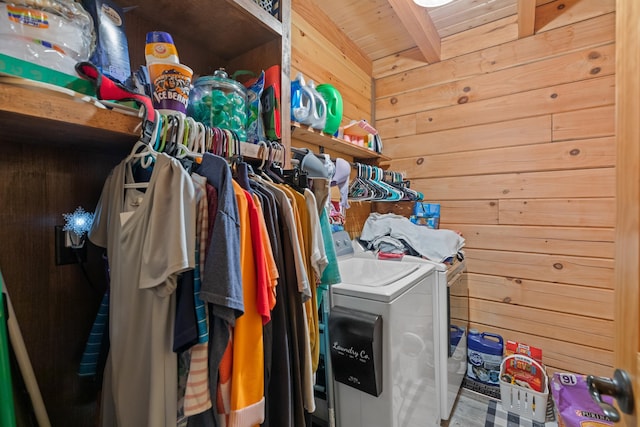 washroom featuring washer and dryer, wooden walls, and wood ceiling