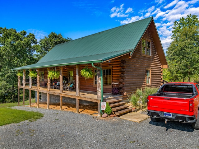 log-style house with a porch