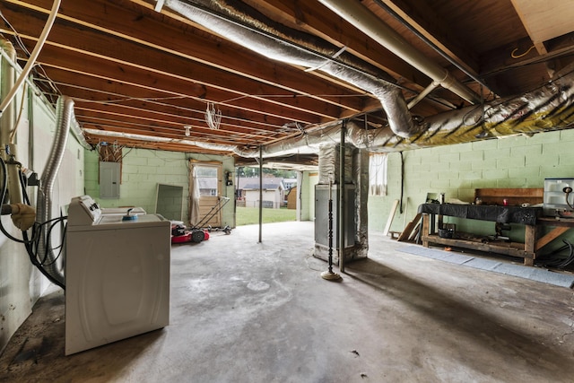 basement with electric panel and washing machine and clothes dryer