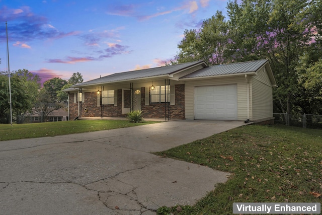 ranch-style home with a porch, a yard, and a garage