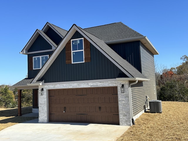 view of home's exterior featuring a garage and central air condition unit