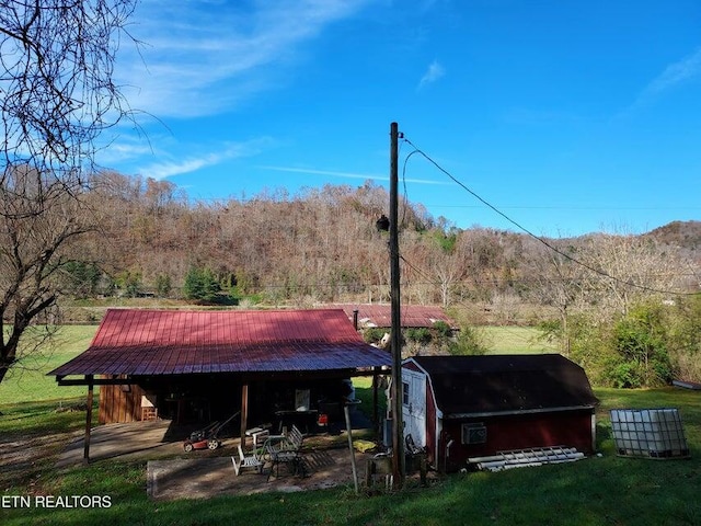 back of property featuring a storage shed