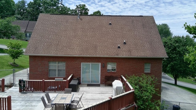 6237 Nightingale St, Morristown, TN 37814 - back of property featuring a deck, fence, brick siding, and outdoor dining area