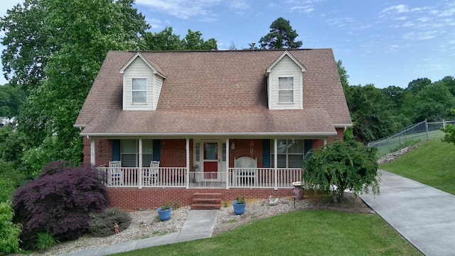 6237 Nightingale St, Morristown, TN 37814 - cape cod-style house featuring a porch, brick siding, and concrete driveway