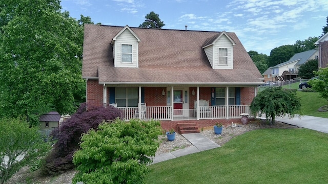 6237 Nightingale St, Morristown, TN 37814 - cape cod house featuring brick siding, a porch, a front lawn, and a shingled roof