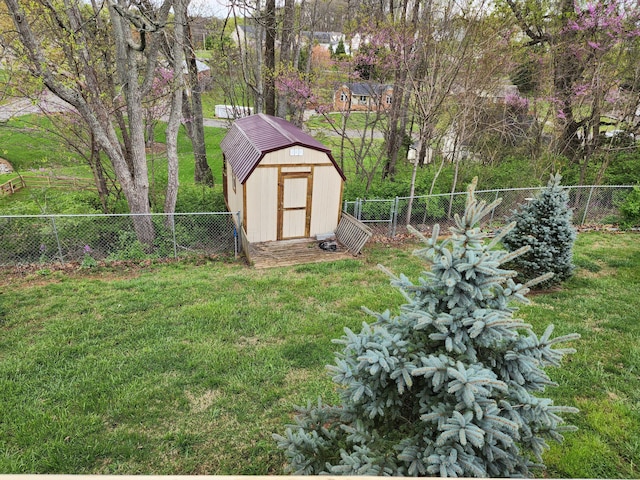 view of yard with a fenced backyard, an outdoor structure, and a shed