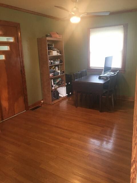 office with dark hardwood / wood-style flooring and ceiling fan