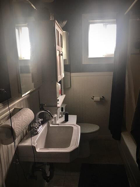 bathroom with tile patterned flooring, toilet, and sink