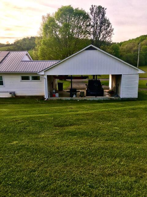 exterior space with a lawn and a carport