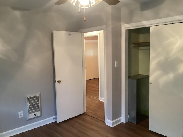 unfurnished bedroom featuring ceiling fan, a closet, and dark hardwood / wood-style floors