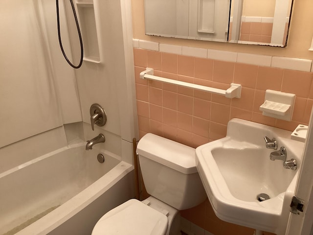 full bathroom with shower / tub combination, toilet, tile walls, and sink