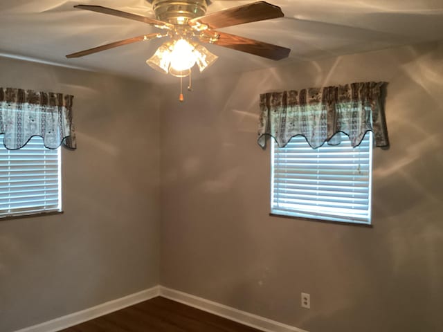 empty room with hardwood / wood-style flooring and ceiling fan