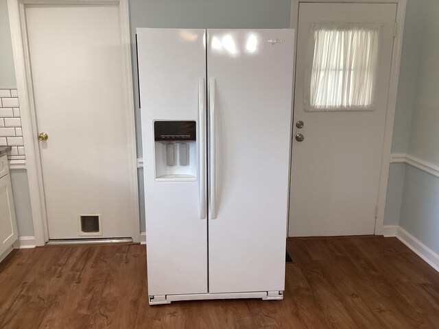 kitchen featuring decorative backsplash, white cabinetry, dark hardwood / wood-style flooring, and white refrigerator with ice dispenser