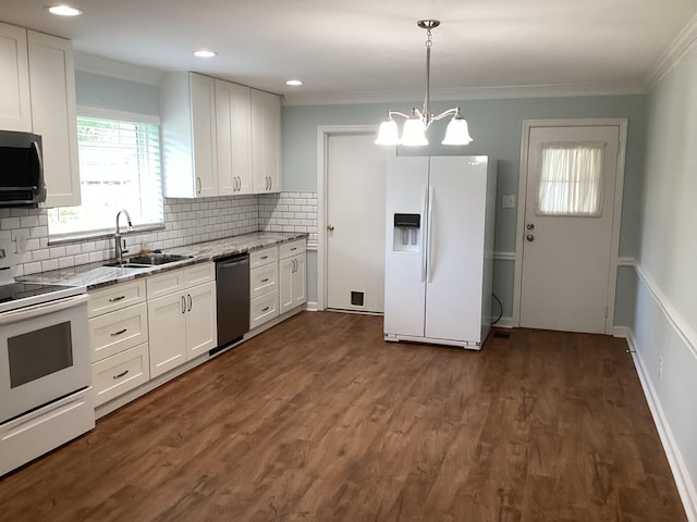 kitchen with sink, dark wood-type flooring, decorative light fixtures, white appliances, and white cabinets