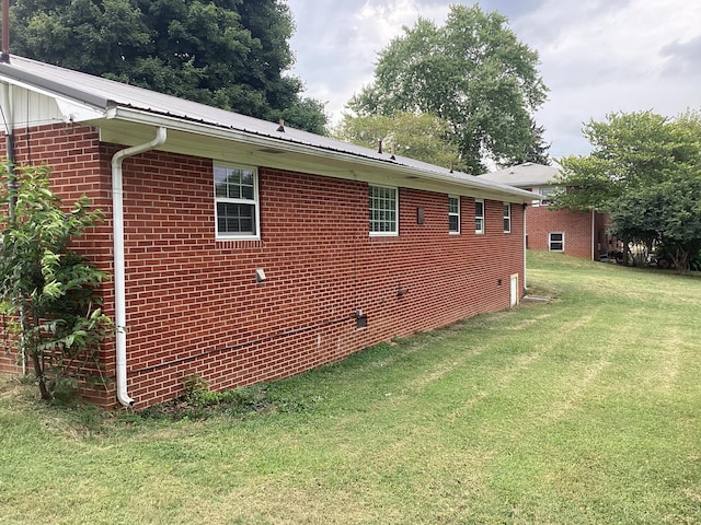 view of side of property with a lawn