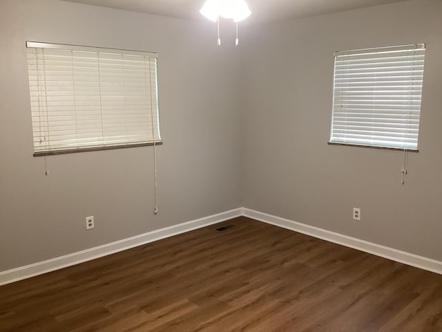 empty room with dark hardwood / wood-style floors