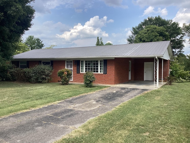 ranch-style home with a front lawn and a carport