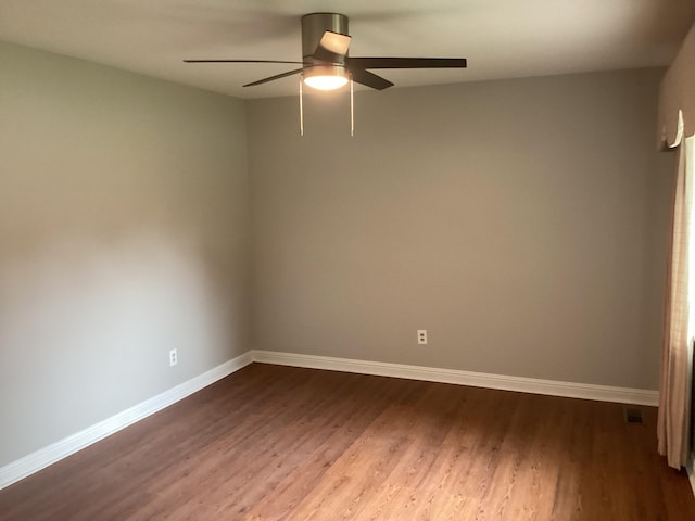 empty room featuring hardwood / wood-style floors and ceiling fan