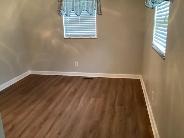 unfurnished dining area with dark hardwood / wood-style flooring