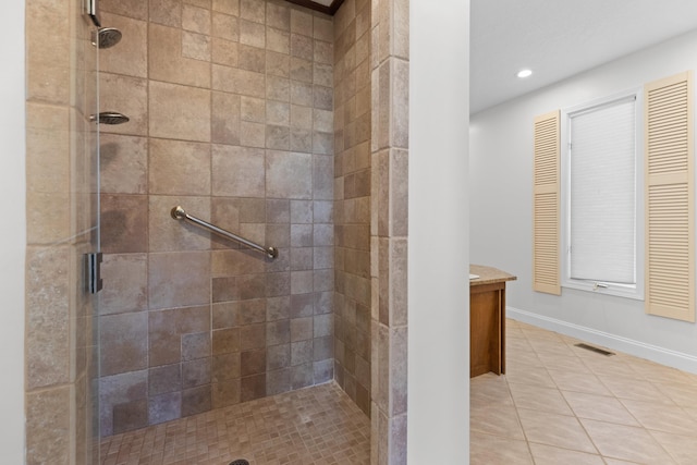 bathroom with tile patterned flooring and walk in shower