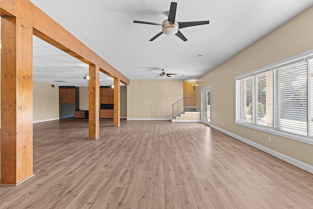 unfurnished living room with hardwood / wood-style floors and ceiling fan