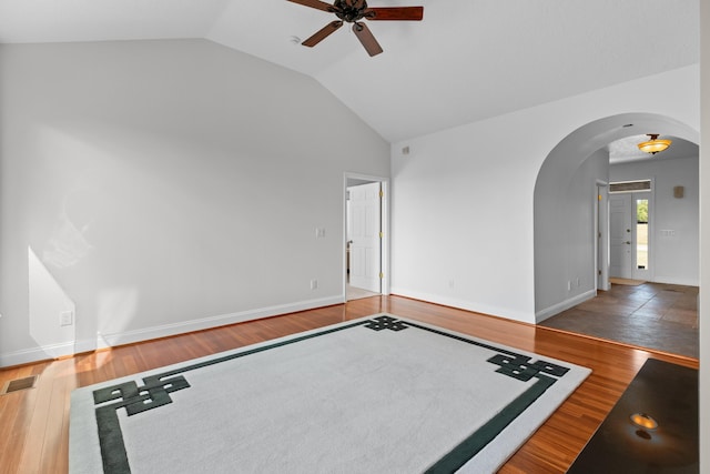 unfurnished room with lofted ceiling, dark wood-type flooring, and ceiling fan