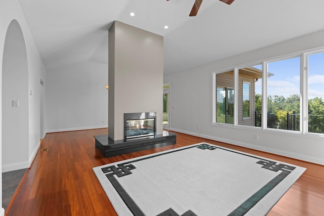 living room featuring ceiling fan, lofted ceiling, and dark hardwood / wood-style flooring