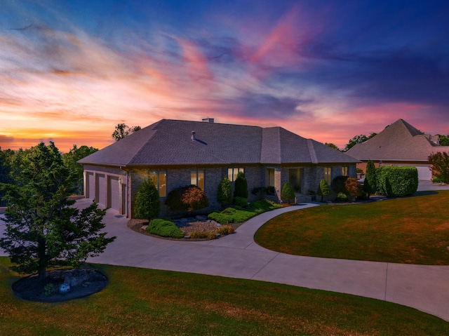 view of front of house with a yard and a garage