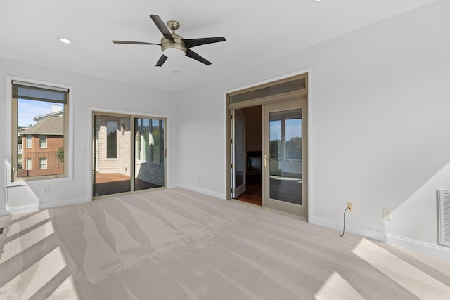 interior space with light colored carpet and ceiling fan