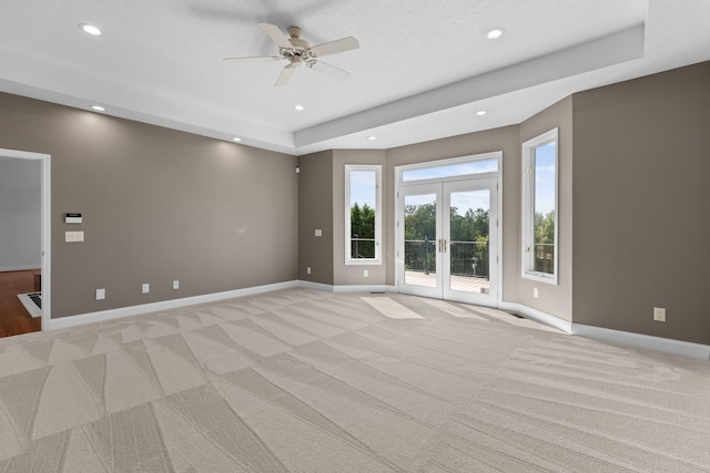 unfurnished room with light colored carpet, ceiling fan, and french doors