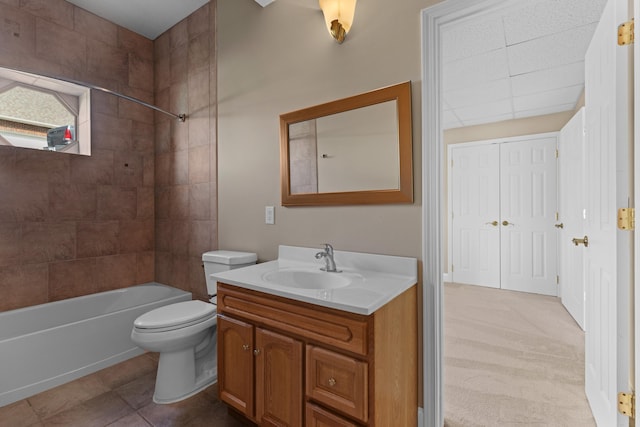 full bathroom featuring tiled shower / bath combo, vanity, tile patterned floors, and toilet