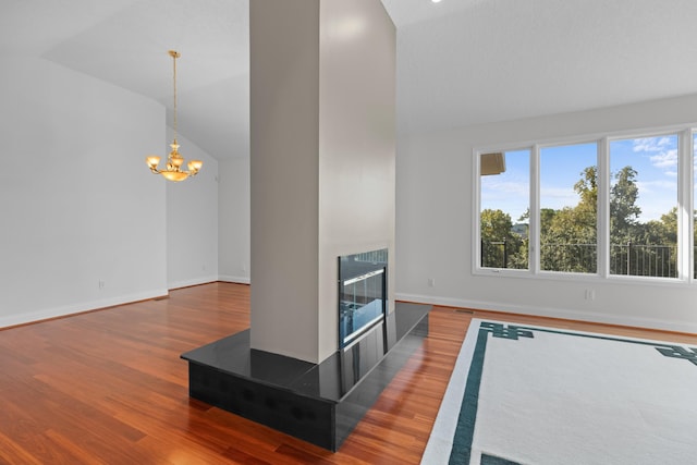 living room featuring an inviting chandelier, high vaulted ceiling, hardwood / wood-style floors, and a tile fireplace