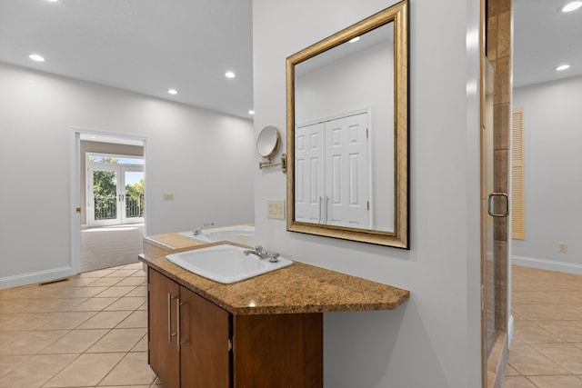 bathroom featuring tile patterned flooring, vanity, and plus walk in shower