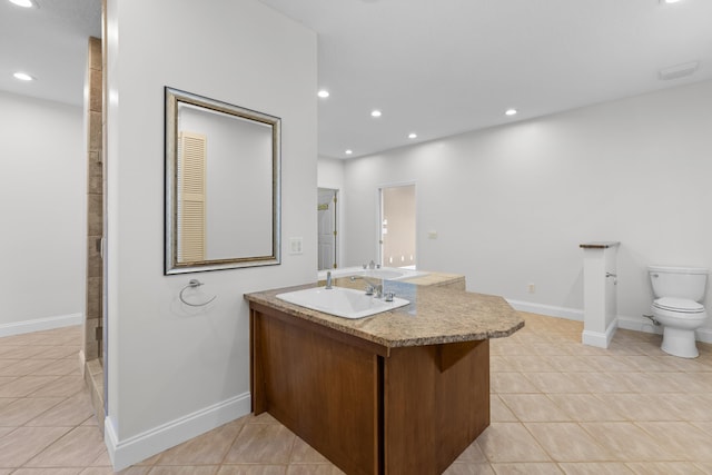 bathroom featuring vanity, tile patterned floors, and toilet