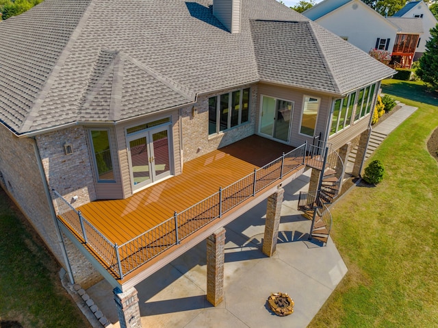 rear view of property featuring a lawn and a patio area