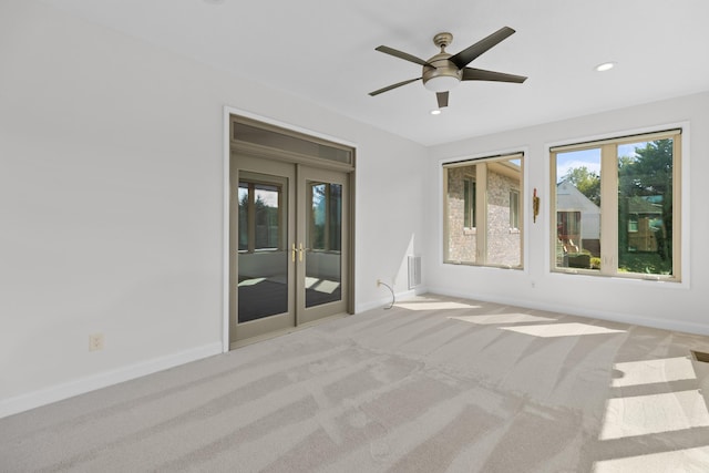 interior space with french doors and ceiling fan